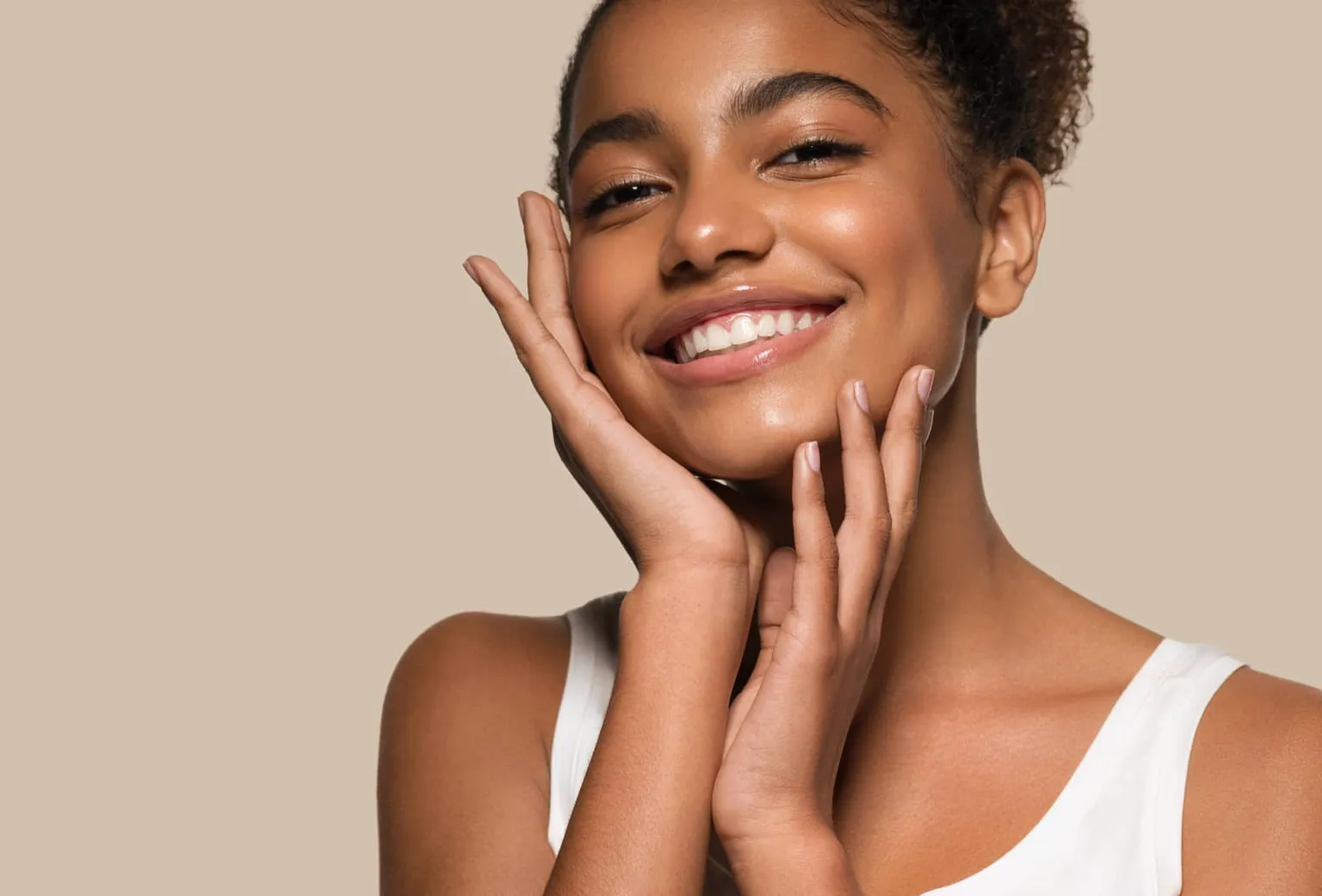 Woman smiling and touching her face