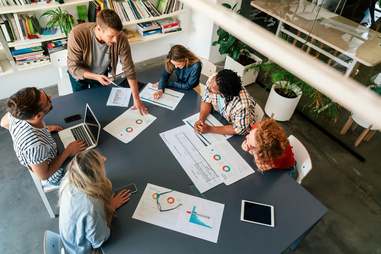People reviewing printed charts together around a table